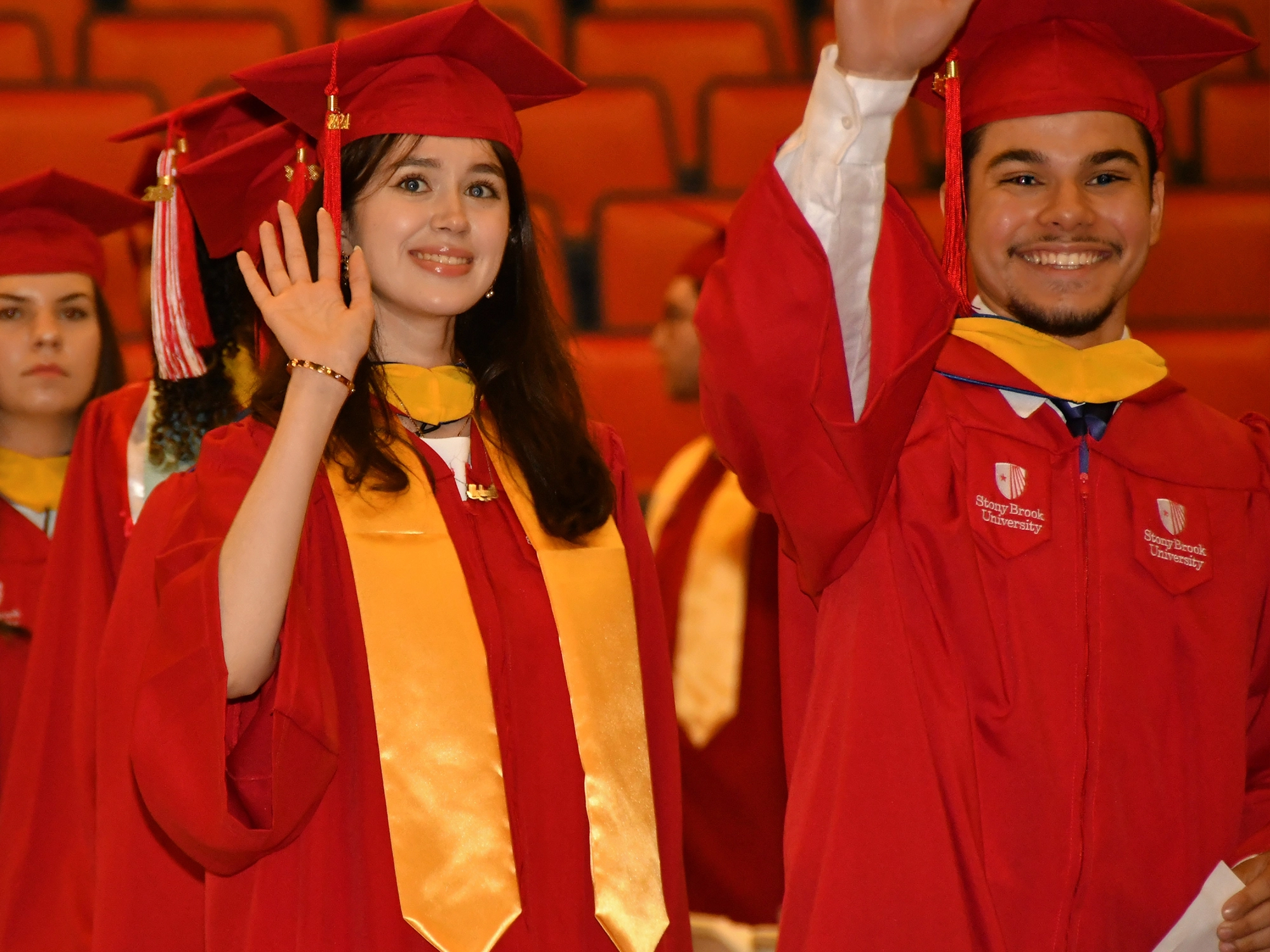 Stony Brook University College of Business student receiving diploma on stage