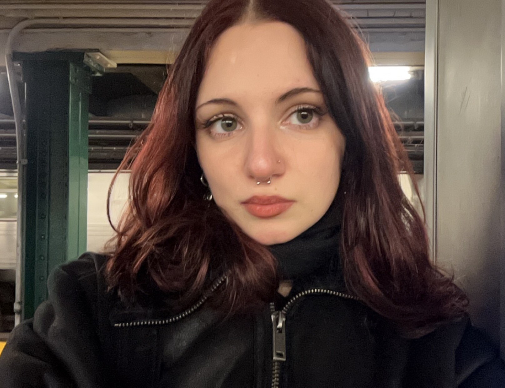 a woman standing in a subway car