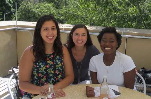 Two Center Scholars Seated Outdoors with Center Staff