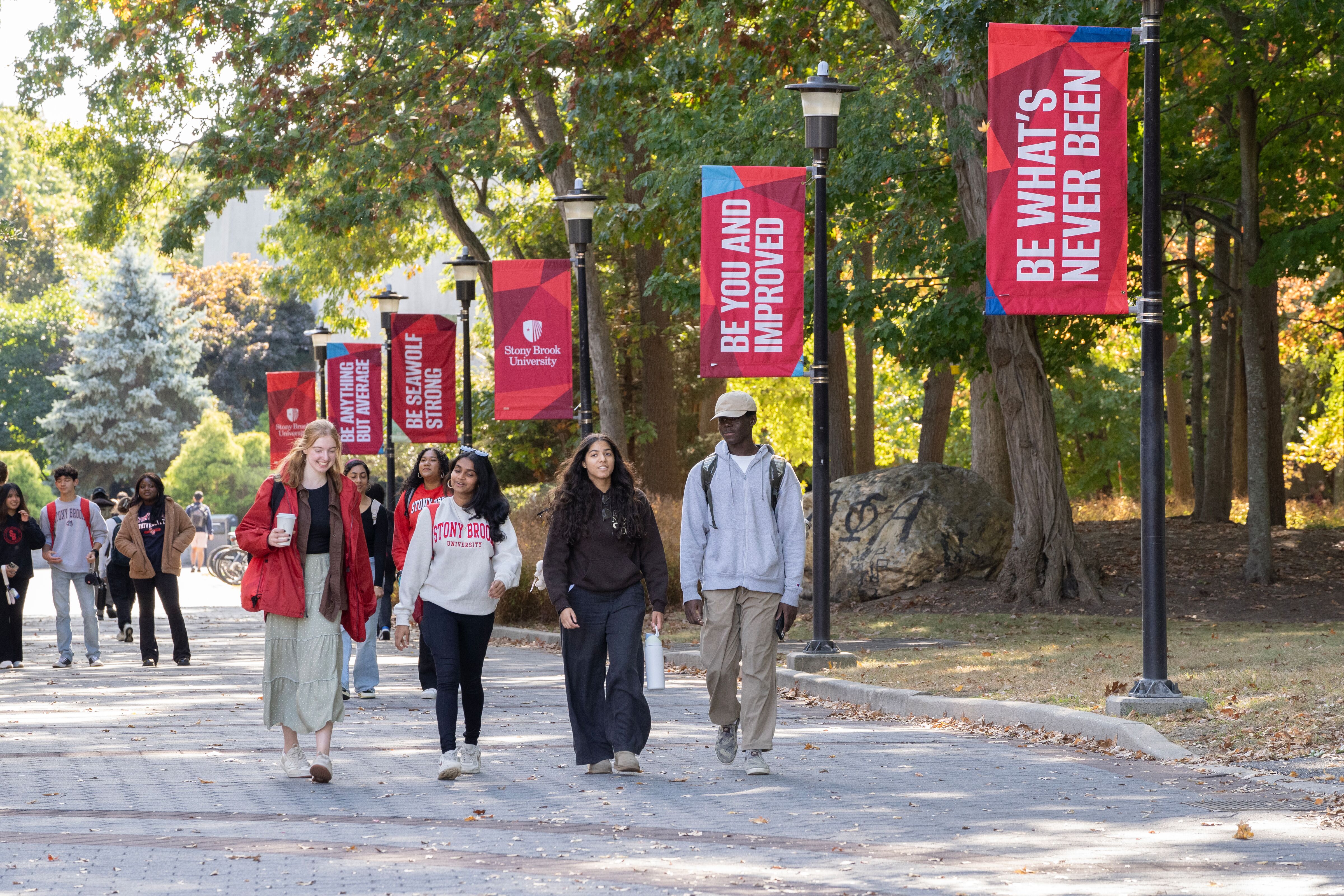 students walking together with new brand banners on display