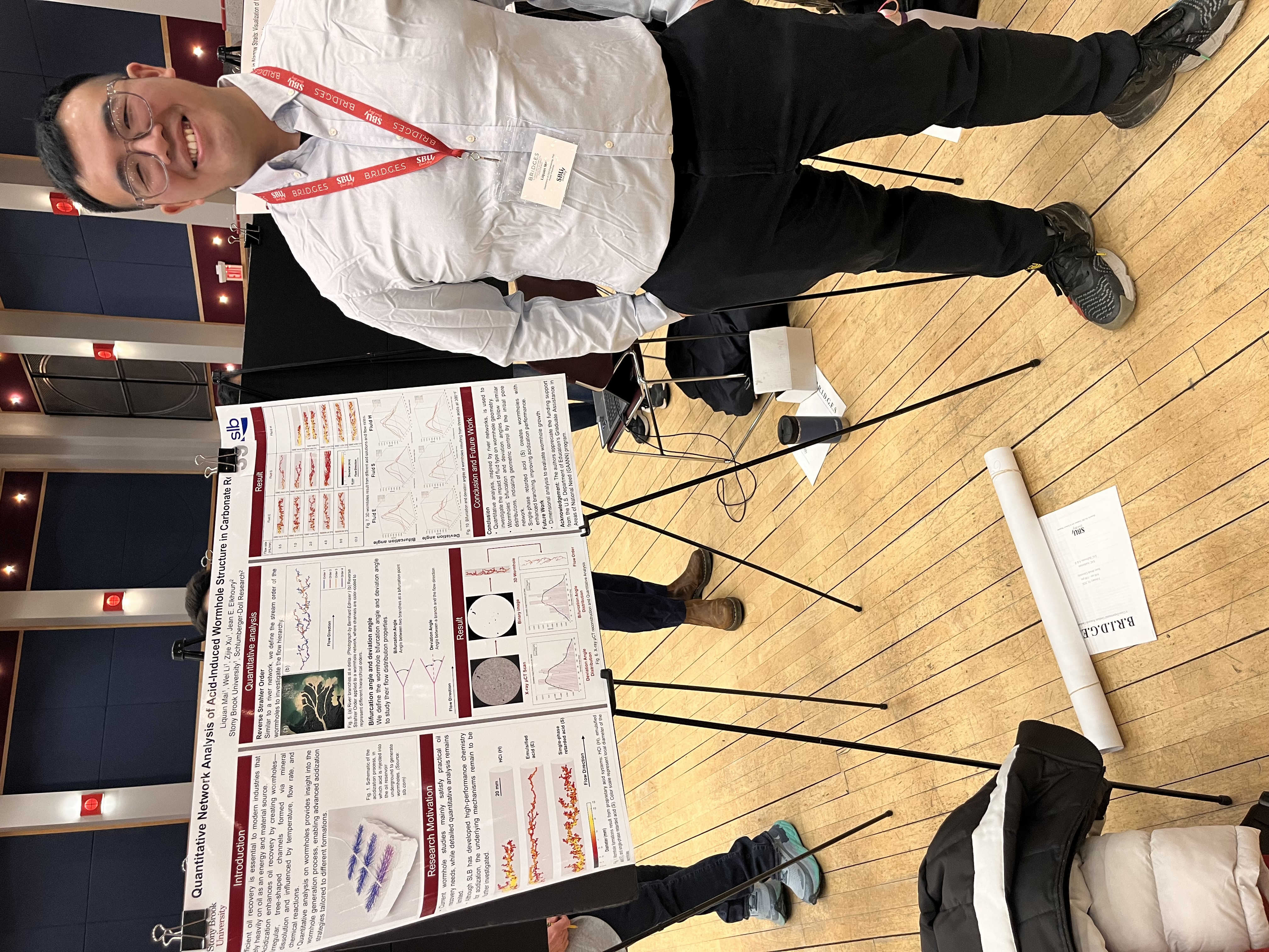 L. Mai with poster