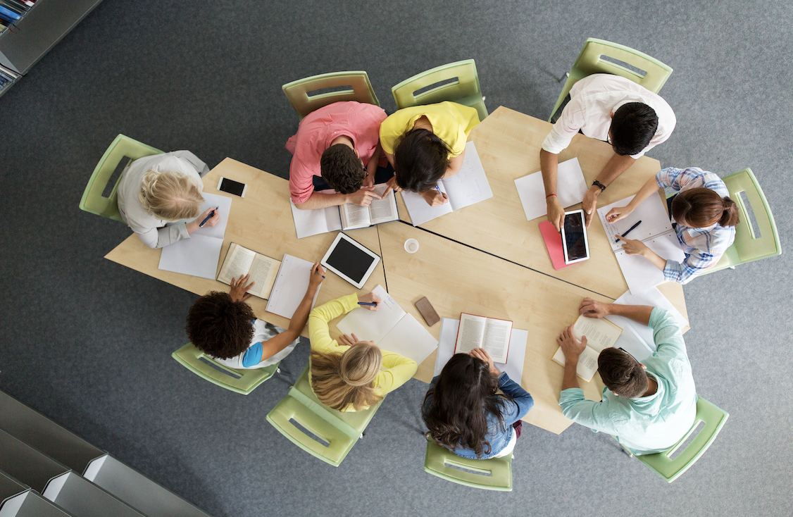 a group of professionals sit together to collaborate 