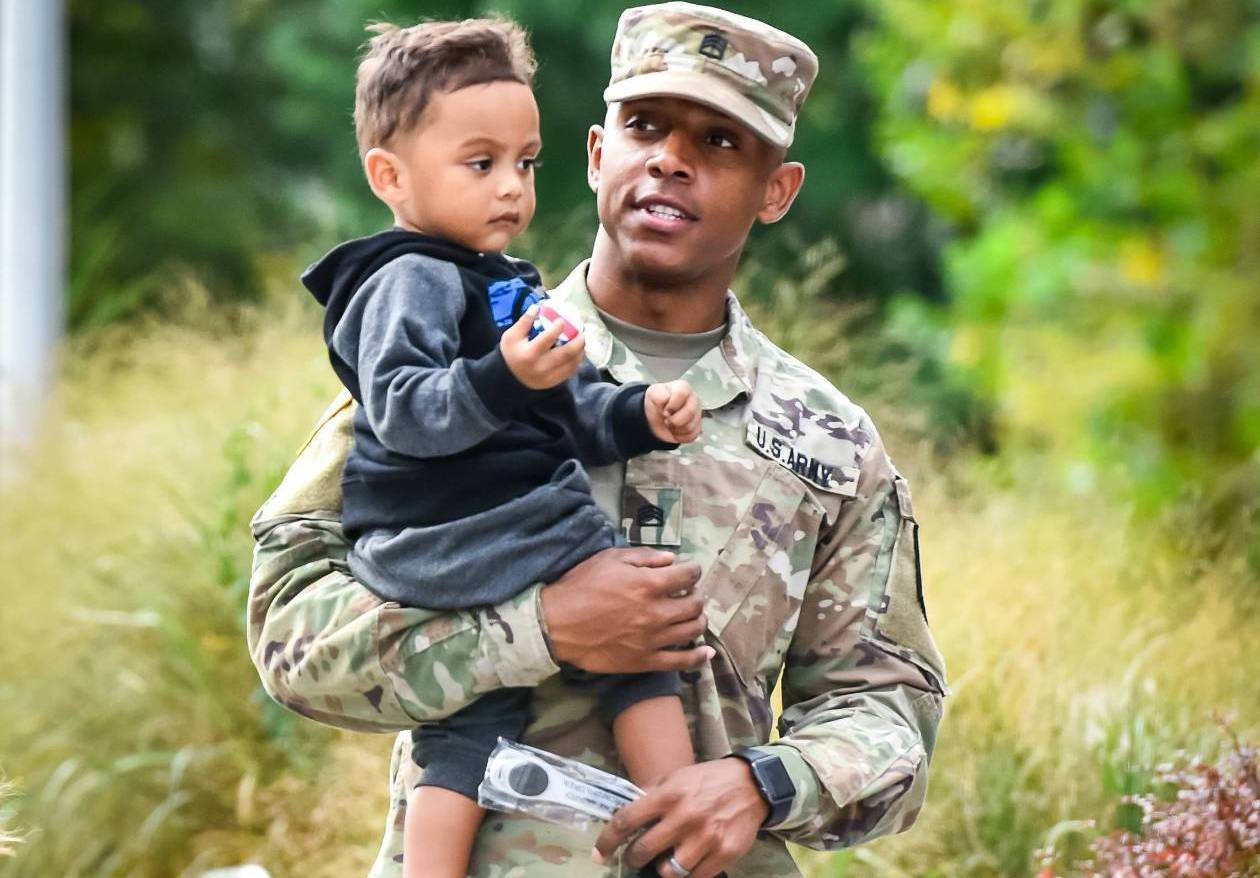 Soldier carrying child