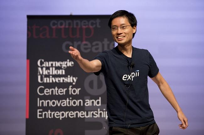 Po-Shen Loh speaking in front of a crowd