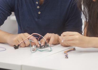 Two students building a device together