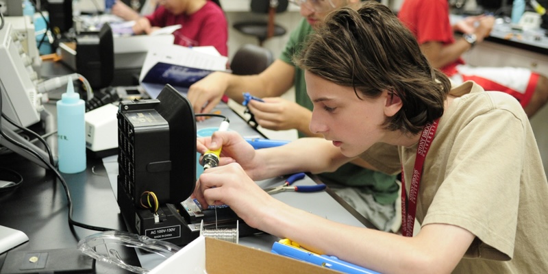 A student practicing his soldering skills