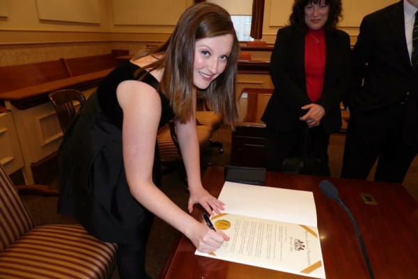 Katie Kennedy signing documents