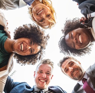 Group of people circled around smiling